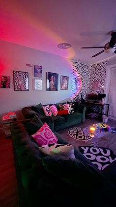 a living room filled with furniture and pictures on the wall