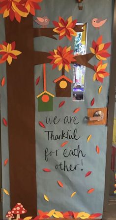 a door decorated with fall leaves and trees