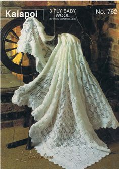 an image of a white crocheted blanket on a chair