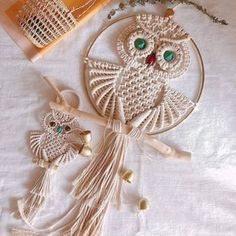 an owl ornament with beads and tassels on a white tablecloth