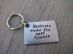 a metal keychain with the words brothers make the best friends written on it