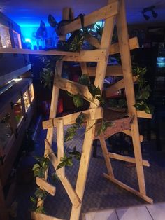 a ladder made out of wooden planks with plants growing on it in a living room