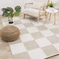 a living room with a checkered rug, chair and potted plant