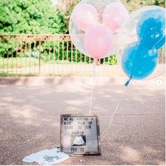 some balloons and a sign on the ground