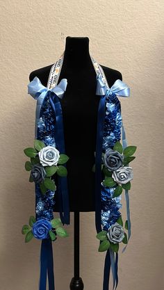 a black mannequin with blue and silver flowers on it