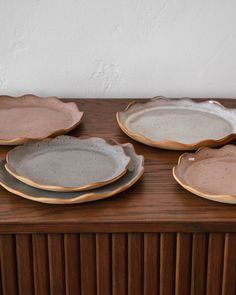 four plates sitting on top of a wooden table