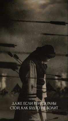 a black and white photo of a person holding skis