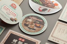 various business cards and stickers on a table with food items in chinese writing,