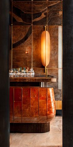 an elegant bar with marble counter tops and gold accents