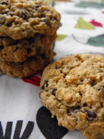 three oatmeal cookies sitting on top of a table