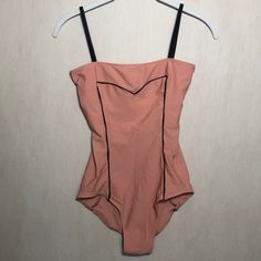 a woman's bodysuit hanging on a hanger