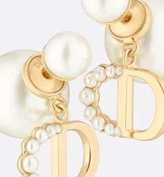 The elegant Dior Tribales earrings offer a new sleek, couture interpretation of an iconic House style. The hallmark pearls are adorned with the CD signature in gold-finish metal, embellished with small resin pearls in varying sizes adorning the letter C. Delicate and timeless, the earrings can be worn with creations from the 30 Montaigne line.. The Letter C, Couture Looks, Letter C, Gold Finish, Metallica, Gold Earrings, Cd, Dior, House Styles