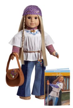 a doll with blonde hair holding a purse next to a book and cd case on a white background