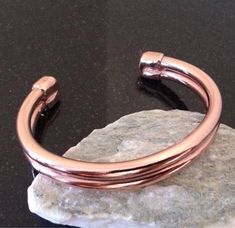 Men's Copper Bracelet - This is a handmade pure copper bracelet that fits very comfortably and is the perfect weight for a man or a woman who prefers a heavier bracelet. It is forged out of new heavy 4 gauge pure copper wire and is approximately 1/2 inch (1.27 cm) wide. I annealed a single piece of wire, formed it into the desired size bracelet and soldered a copper cap to each end for additional style and comfort. After shaping for a perfect fit, it was tumbled in a jewelers mix to polish for a Mens Copper Bracelet, 7th Anniversary Gifts, 7th Anniversary, Copper Bracelet, Pure Copper, Silver Jewellery, Single Piece, Copper Wire, Bracelets For Men