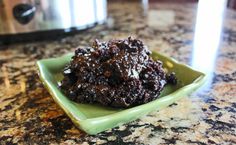 a green plate topped with brownies on top of a counter