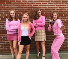 four young women in pink outfits posing for a photo with their hands on their hipss