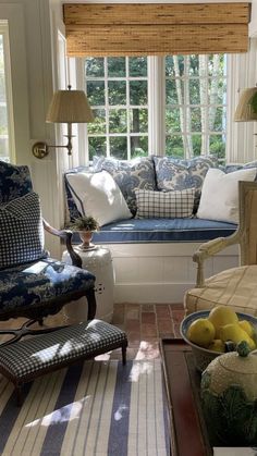 a living room filled with furniture and windows