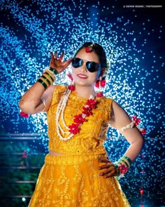 a woman in a yellow dress is posing for the camera with her hands on her head