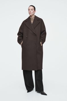 A modern take on heritage, this chocolate-brown herringbone coat is tailored with neat notch lapels and a double-breasted close. It's crafted from a recycled-wool blend that will provide warmth in the winter months and cut in a relaxed shape that accommodates chunky knitwear underneath. It features a vent at the back and pockets in the side seams. Relaxed fitButton closureInternal pocketRecycled wool is made from yarn-spinning waste, yarn overstock, production-cutting waste and post-consumer garments – creating new pieces without waste  Shell: 70% Recycled wool, 30% Polyamide. Lining: 100% Viscose. Excluding trims / Dry clean Back length of size S is 114.2cm / Model wears a size S Belted Cape, Herringbone Coat, Pull Oversize, Winter Outfits Cold, Accessories Bags Shoes, Women Magazines, Cardigan Shirt, Chunky Knitwear, Brown Coat