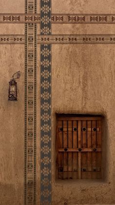 an old building with a small window in the wall and a clock on the side