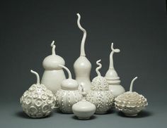 a group of white vases sitting next to each other