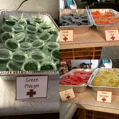 several trays filled with different colored candies on top of a counter next to each other