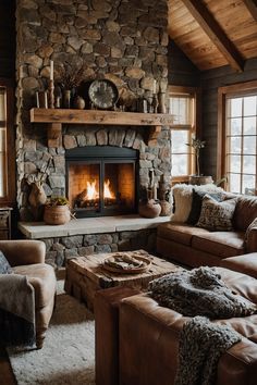 a living room filled with furniture and a fire place next to a stone wall covered in logs