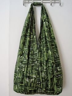 a large green bag hanging on a wall