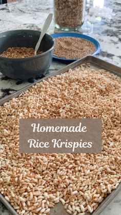 homemade rice krispies in pans on a table with bowls and measuring spoons