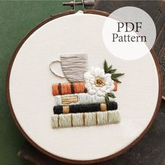 a cross stitch pattern with a coffee cup and stack of books