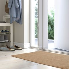 a pair of slippers sitting on top of a wooden floor next to a door