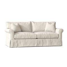 a white couch with two pillows on it's back and the seat upholstered