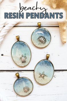 three seashell pendants with the words beachy resinin pendants on them