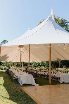 a large tent set up with tables and chairs