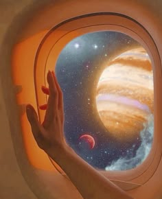 a person's hand is looking out an airplane window at the planets