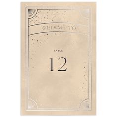 a table number card with an art deco style frame and the word welcome to on it