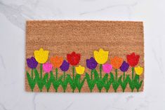 a door mat with flowers painted on it