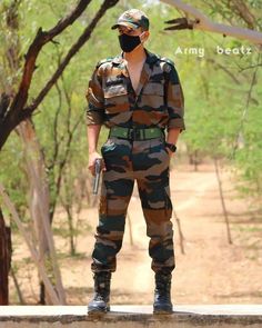 a man in camouflage is standing on a wall