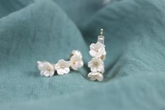 These white floral silver earrings are handmade women earrings. These earrings are simple and elegant accessories that you can easily match with any outfit. These earrings are perfect for gifting yourself or your loved ones. They are great gift options for birthday, wedding, engagement, anniversary, Valentine's day, Mother's day, graduation or any special occasion. These earrings come with gift box and personalized note. The size of the earrings is 1 cm. Color: Gold & White Style: Bridal, Weddings, Special Days, Summer Style Gender: Unisex Shape: Floral, Pearl Material: Cubic zirconia Return policy Our products have a one-day preparation period, during which you can cancel or change your order. If you want to make a return or exchange after your order has been shipped, the shipping charges Elegant Handmade Flower Earrings For Her, Elegant Handmade Flower Earrings As Gift For Her, Handmade Elegant Flower Earrings As Gift, Elegant Flower-shaped Hoop Earrings Gift, Elegant Flower-shaped Hoop Earrings For Wedding, Dainty White Pearl Earrings For Party, Elegant White Flower Hoop Earrings, Handmade Clip-on Earrings For Wedding, Elegant Flower Shaped Wedding Hoop Earrings