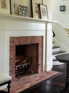 a fire place sitting in the middle of a living room next to a stair case