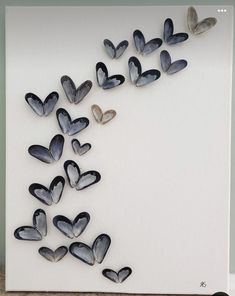 a white wall with lots of hearts on it in the shape of a wave and butterflies