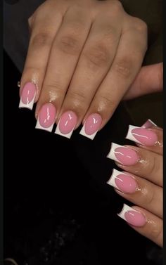 two hands with pink and white manies on their nails, one is holding the other hand