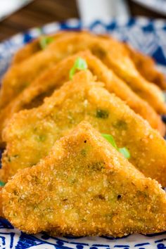 some fried food on a blue and white plate