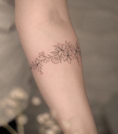 a woman's arm with flowers on it