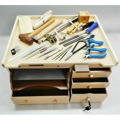 an assortment of tools are sitting in a drawer