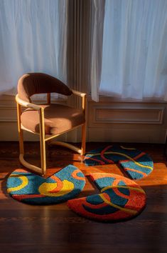 a chair and rugs in front of a window with the word may on it