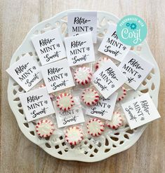 small peppermints are on a white plate with labels that say different types of mints