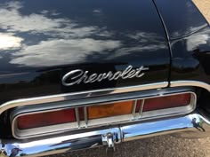 the rear end of a black chevrolet car