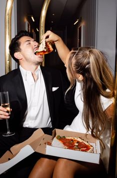 the man and woman are eating pizza together