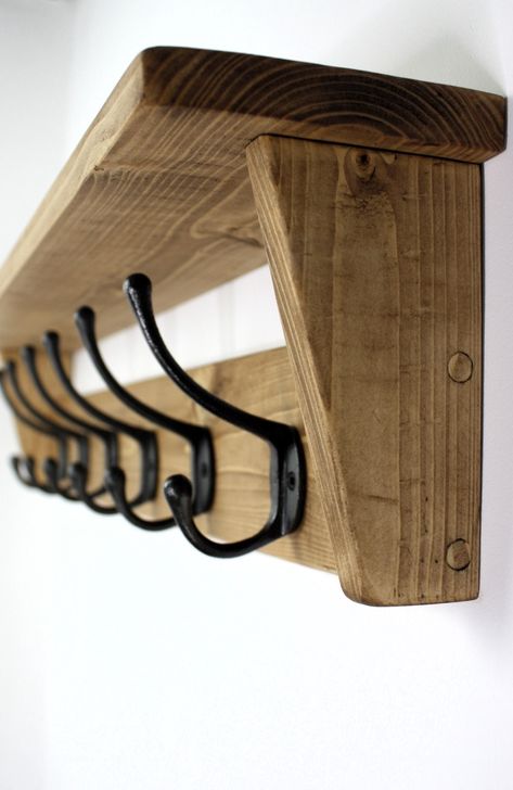 This wall mounted rustic coat rack with shelf and cast iron hooks that adds a little extra to a home. Made from solid wood and finished in a smoked oak shade, it looks great, rustic and traditional. The mounting holes are situated behind the end hooks so no screws are on show and fittings and instructions are provided. The dimensions are (depth) 12cm, (height) 18cm, length is dependent on size you choose. Dimensions, Length. 51cm coat rack (3 hooks) 63cm coat rack (4 hooks) 75cm coat rack (5 hoo Wooden Wall Coat Hanger, Hallway Coat Hanging Ideas, Hallway Hanger Ideas, Coat Hanger Ideas Front Entry, Coat Hook Ideas, Coat Hanger Ideas, Coat Rack Wall Entryway, Coat Rack Ideas, Mudroom Wall Hooks